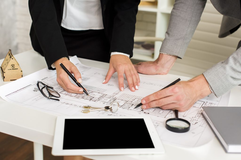 architects-studying-plan-with-mockup